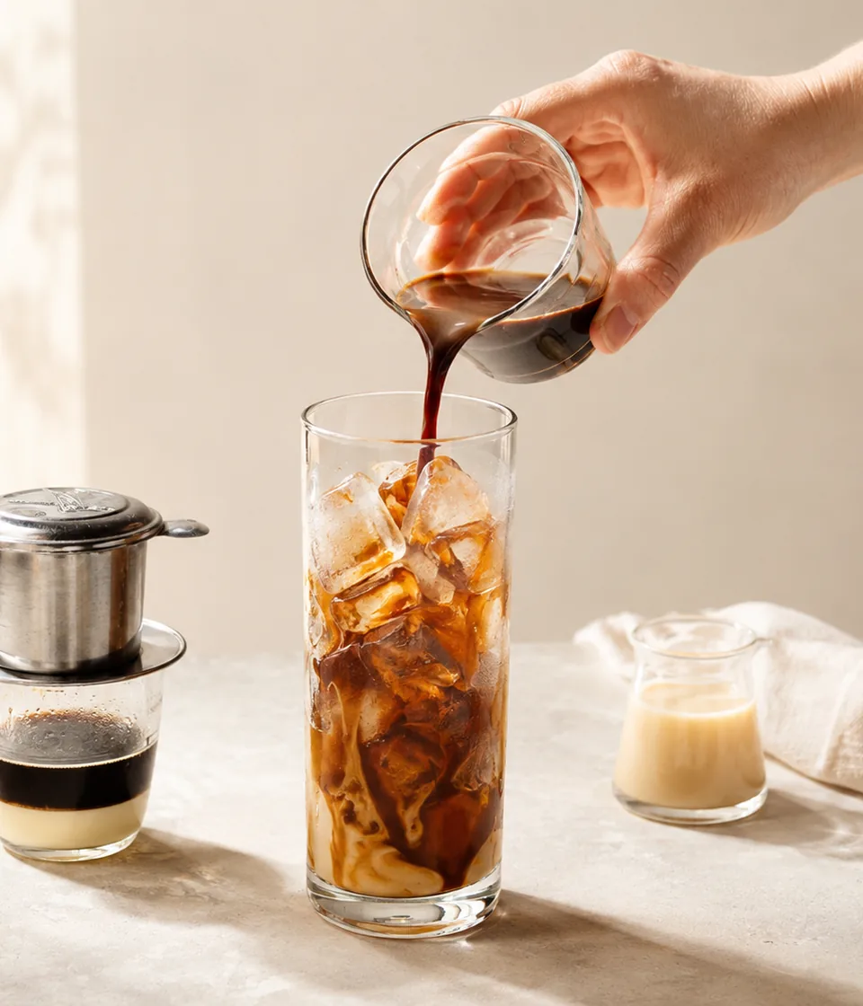 Vietnamese iced coffee being poured over ice